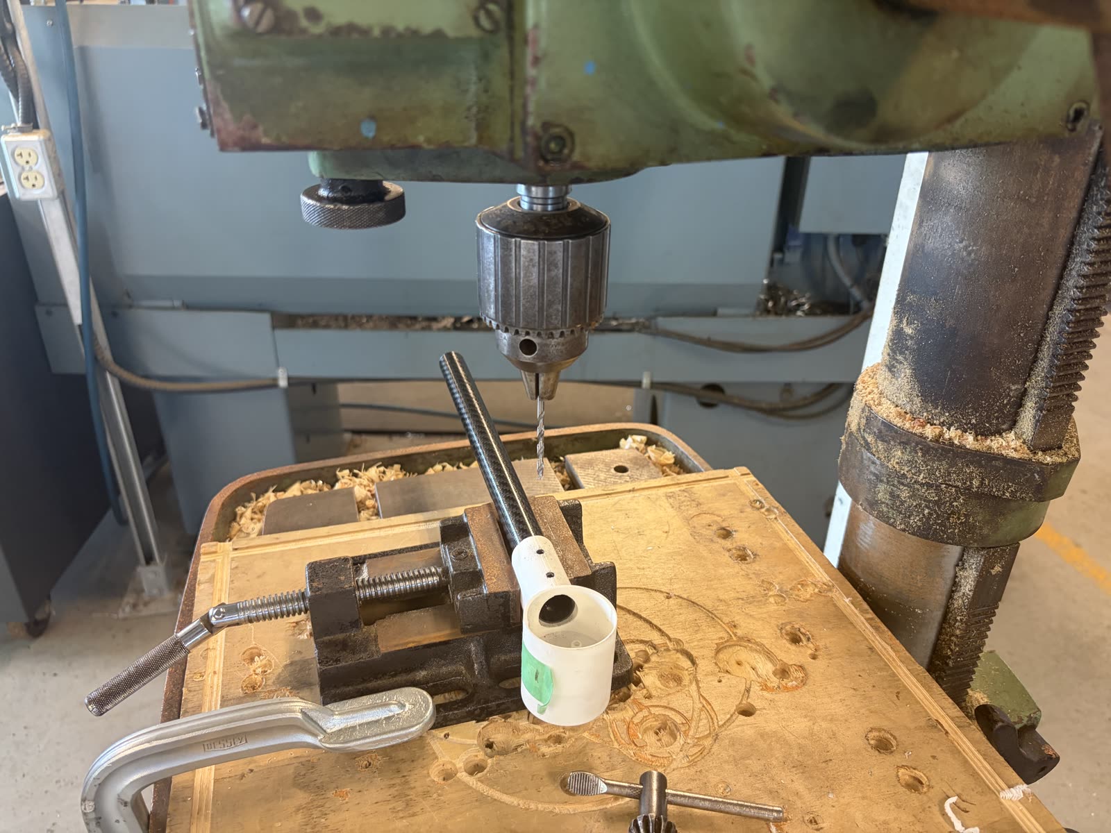 Carbon fiber tube being drilled on a drill press